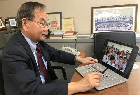 Yu-Taik Chon, president of Pyongyang University of Science and Technology (PUST), shows a picture of students attending a class in PUST, at his office in Seoul, South Korea, June 14, 2018. REUTERS/Park Ju-min