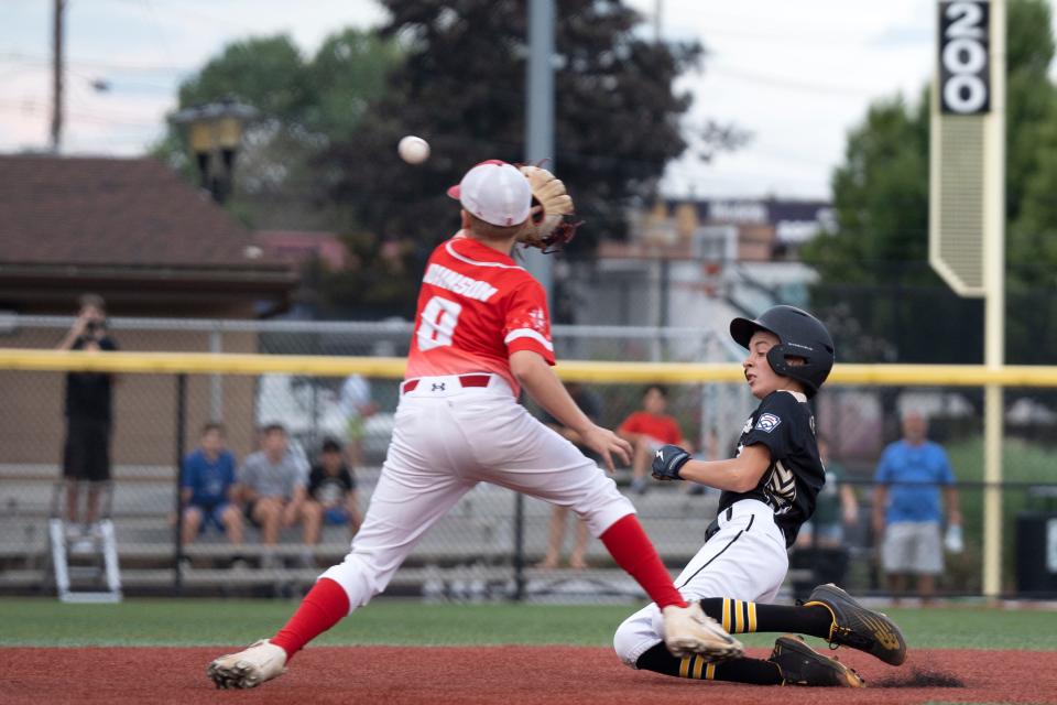 Holbrook vs. East Hanover in the New Jersey Little League Baseball tournament at Buchmuller Park in Secaucus on Saturday, July 29, 2023. East Hanover #11 Anthony Abrantes on his way to being safe at second as Holbrook #8 Dylan Johnson tries to get the out.