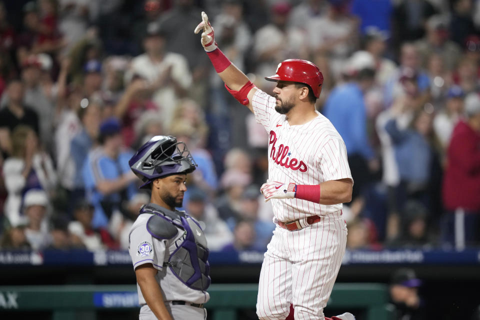 Philadelphia Phillies' Kyle Schwarber, right, reacts after hitting a home run against Colorado Rockies relief pitcher Dinelson Lamet during the seventh inning of a baseball game, Friday, April 21, 2023, in Philadelphia. (AP Photo/Matt Slocum)