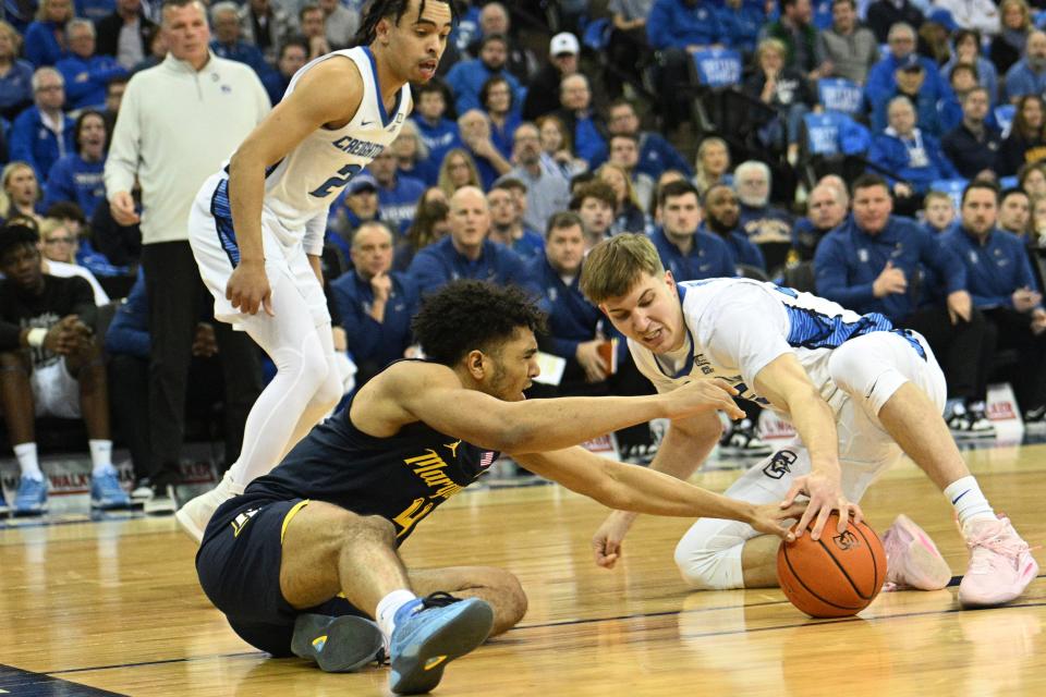 Marquette guard Stevie Mitchell and Creighton's Baylor Scheierman battle for a loose ball in the first half on Tuesday.