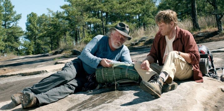 Two men talk on a rock in A Walk in the Woods.