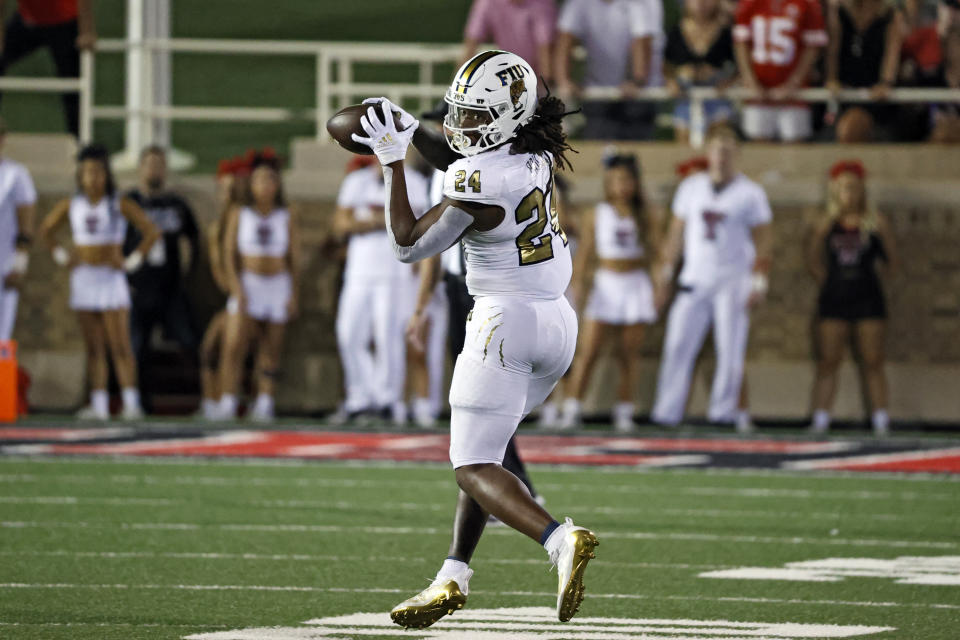 Florida International's D'vonte Price (24) catches a pass during the second half of an NCAA college football game against Texas Tech, Saturday, Sept. 18, 2021, in Lubbock, Texas. (AP Photo/Brad Tollefson)