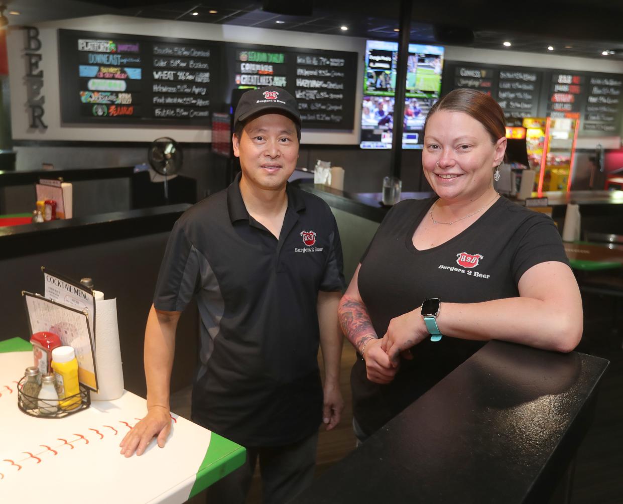 Burgers 2 Beer owner Yong Hao Chen and manager Nicole Magee show off the new restaurant June 29 in Twinsburg.