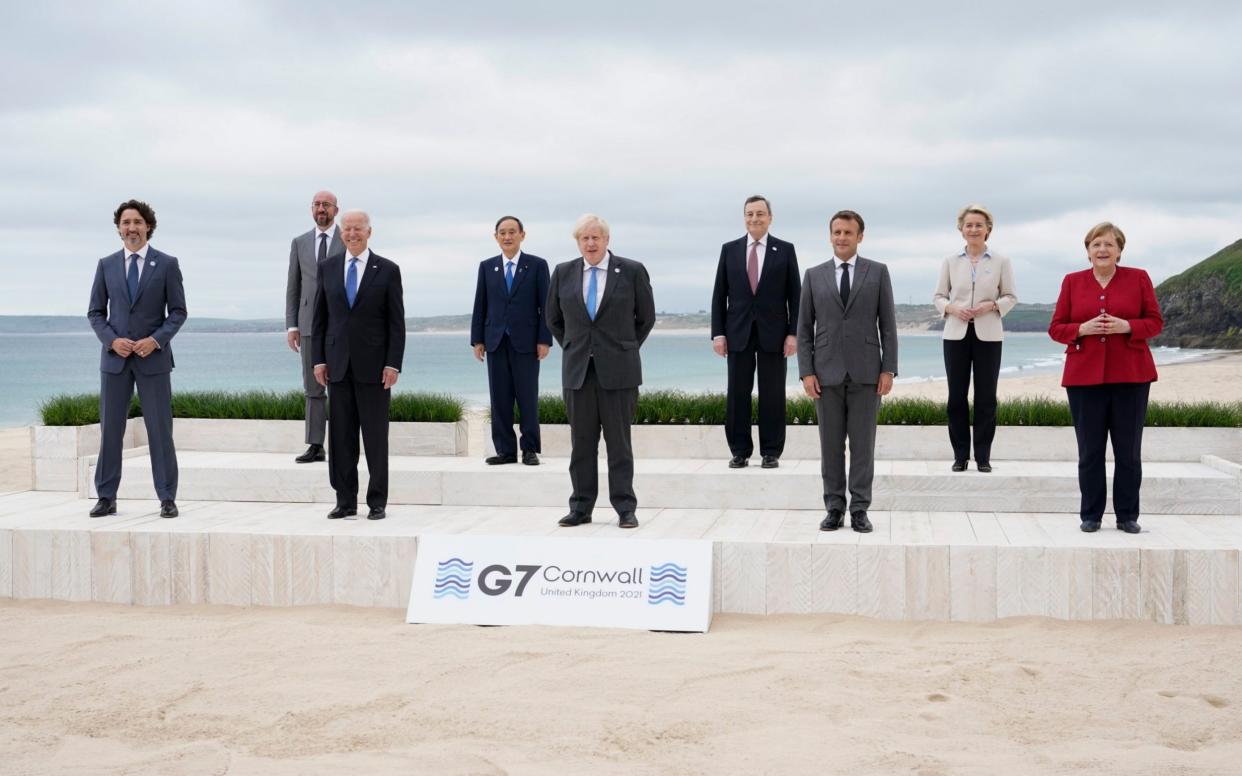 G7 leaders pose for a group photo on the beach in Cornwall - AP Photo/Patrick Semansky