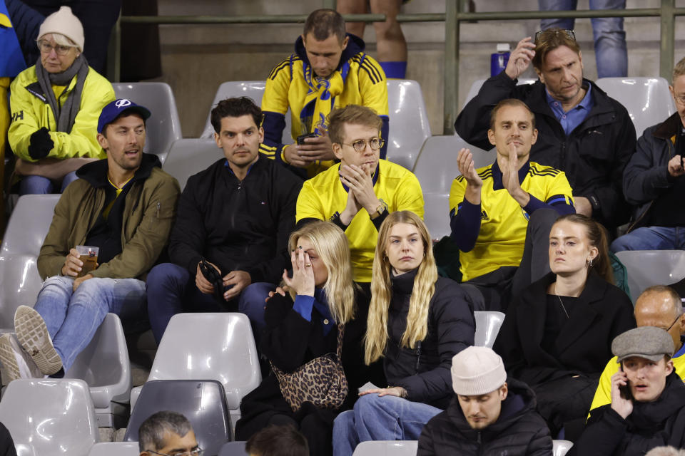 Sweden supporters react on stands during the Euro 2024 group F qualifying soccer match between Belgium and Sweden at the King Baudouin Stadium in Brussels, Monday, Oct. 16, 2023. Two Swedes were killed in a shooting late Monday in central Brussels, police said, prompting Belgium's prime minister and senior Cabinet minister to hunker down at their crisis center for an emergency meeting. (AP Photo/Geert Vanden Wijngaert)