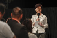 Hong Kong Chief Executive Carrie Lam speaks during a community dialogue with selected participants at the Queen Elizabeth Stadium in Hong Kong, Thursday, Sept. 26, 2019. Scores of protesters chanted slogans outside the venue as Lam began the town hall session Thursday aimed at cooling down months of demonstrations for greater democracy in the semi-autonomous Chinese territory. (AP Photo/Kin Cheung)