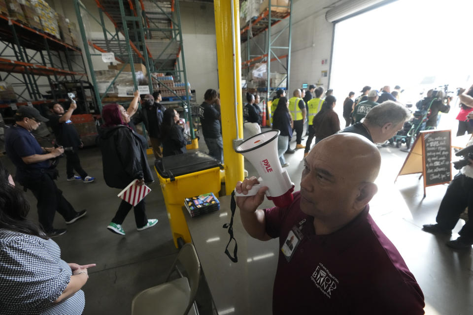 Workers evacuate a sharehouse as they participate on a ShakeOut earthquake drill at the Los Angeles Regional Food Bank in Los Angeles Thursday, Oct. 19, 2023. Up and down the West Coast, the ShakeOut drill was scheduled to begin at 10:19 a.m. PDT with a cellphone-rattling test alert from the region's ShakeAlert earthquake warning system. (AP Photo/Damian Dovarganes)