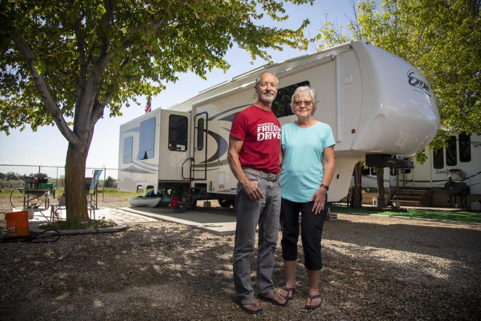Jean and Duane Mathes with their RV home at the Hi Valley RV Park in Eagle, Idaho. Jean and Duane made it to their reservation at Hi Valley but found many RV parks closed on their way to Idaho from Arizona. (Photo: Kyle Green for HuffPost)