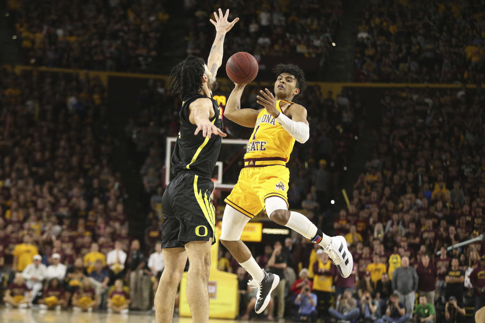 Arizona State's Remy Martin (1) looks for an open teammate as Oregon's Addison Patterson (22) defends during the second half of an NCAA college basketball game Thursday, Feb. 20, 2020, in Tempe, Ariz. (AP Photo/Darryl Webb)