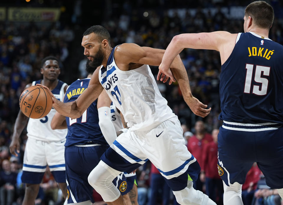 Minnesota Timberwolves center Rudy Gobert, front left, is fouled by Denver Nuggets center Nikola Jokic during the second half of an NBA basketball game Wednesday, April 10, 2024, in Denver. (AP Photo/David Zalubowski)