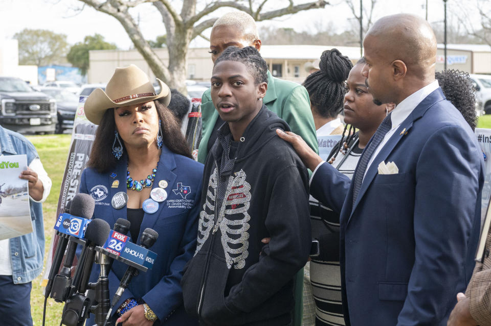 Dr. Candice Matthews, left, listens as state representative Ron Reynolds, right, with Darryl George, center, makes comments before a hearing regarding George's punishment for violating school dress code policy because of his hair style, Thursday Feb. 22, 2024 at the Chambers County Courthouse in Anahuac, Texas. A judge has ruled that George's monthslong punishment by his Texas school district for refusing to change his hairstyle does not violate a new state law prohibiting race-based hair discrimination. (Kirk Sides/Houston Chronicle via AP)