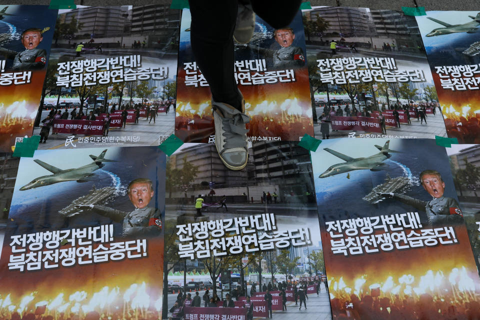 <p>A woman walks across posters featuring President Donald Trump during a protest ahead of Trump’s visit near the U.S. Embassy in Seoul, South Korea, on Saturday, Nov. 4, 2017. (Photo: Seong Joon Cho/Bloomberg via Getty Images) </p>