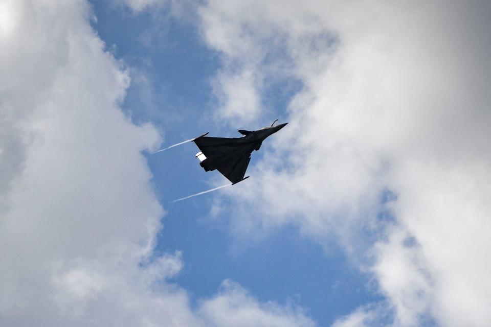 This photograph taken on June 23, 2023, shows a Rafale fighter jet performing an exhibition flight demonstration during the International Paris Air Show at the Paris-Le Bourget Airport.  / Credit: CHRISTOPHE ARCHAMBAULT/AFP via Getty Images