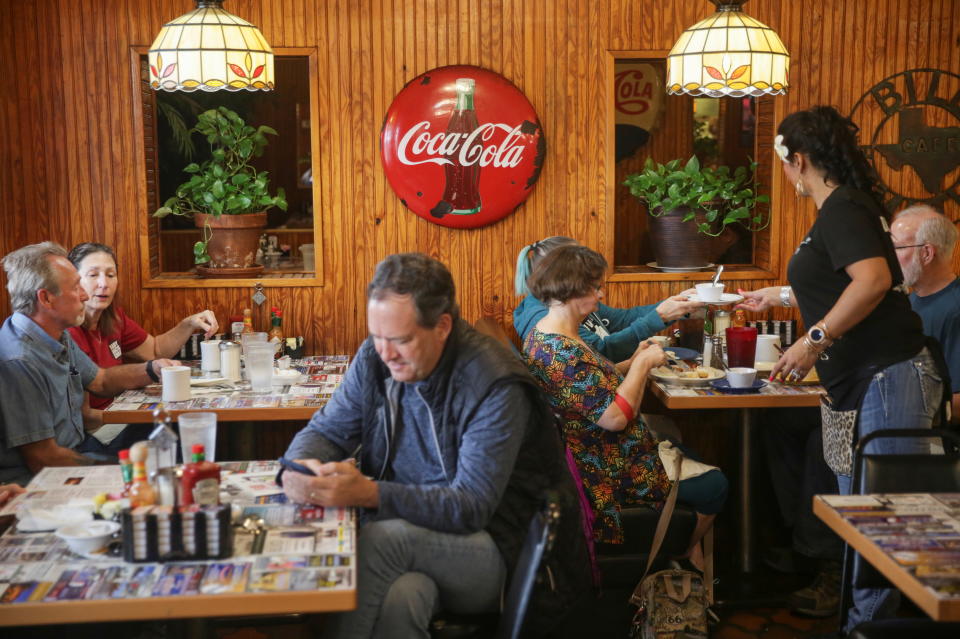 People take breakfast at Bill Smith's Cafe, after Texas Governor Greg Abbott issued a rollback of coronavirus disease (COVID-19) restrictions in McKinney, Texas, U.S., March 10, 2021. REUTERS/Shelby Tauber