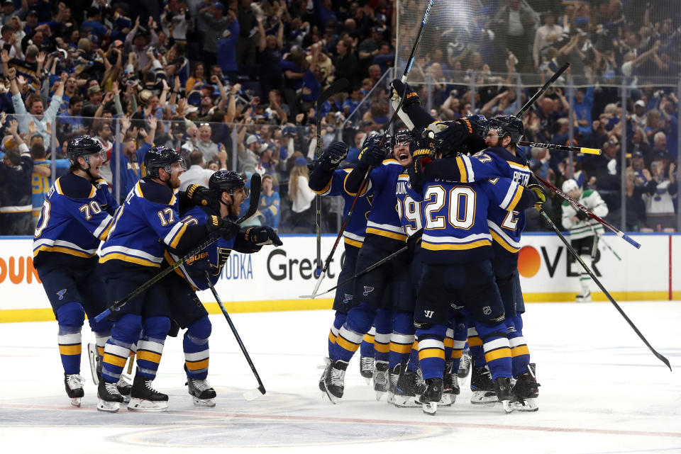 FILE - In this May 7, 2019, file photo, St. Louis Blues celebrate after defeating the Dallas Stars in double overtime in Game 7 of an NHL second-round hockey playoff series in St. Louis. (AP Photo/Jeff Roberson, File)