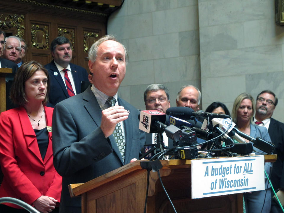 RETRANSMITTING TO REPLACE ENTIRE CAPTION Republican Wisconsin Assembly Speaker Robin Vos joins with fellow Republicans in the Assembly chamber before a planned to vote to pass the GOP's version of the state budget on Tuesday, June 25, 2019, in Madison, Wisconsin. Vos argues the budget is fiscally responsible, while Democrats say it falls short of addressing the state's needs. (AP Photo/Scott Bauer)