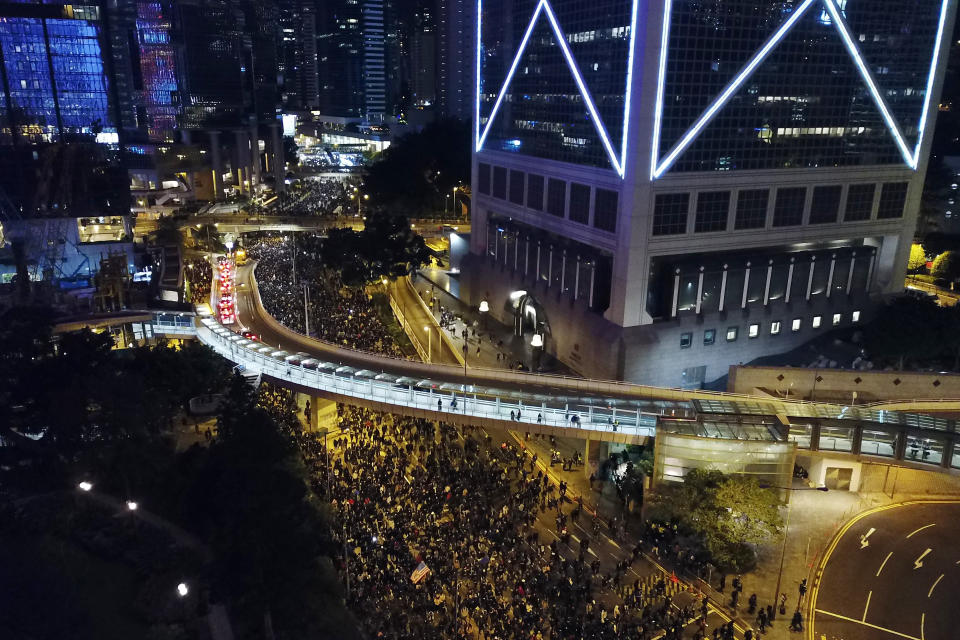 In this Sunday, Dec. 8, 2019, photo, pro-democracy protesters march into the night in central Hong Kong. Hundreds of thousands thronged Hong Kong streets Sunday, in a mass show of support for a protest movement that shows no signs of flagging as it enters a seventh month. (AP Photo/Dake Kang)