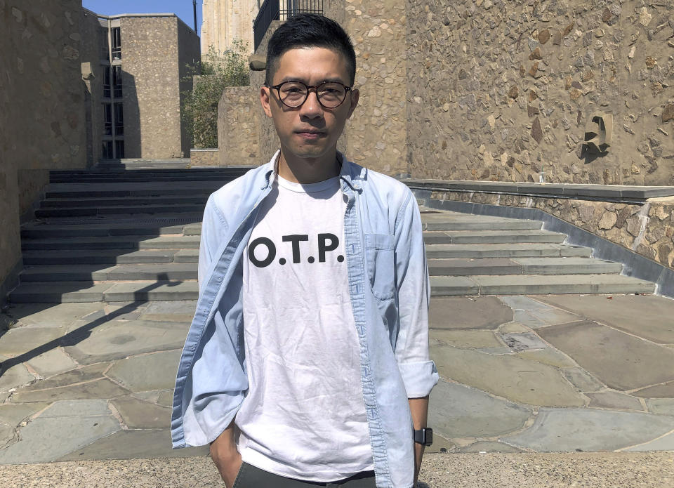 In this Sept. 23, 2019, photo, Nathan Law, a Hong Kong democracy activist and current graduate student at Yale, poses on the school campus in New Haven, Conn. Law gained prominence as a student protest leader before winning election to Hong Kong's legislature in 2016. He later was expelled and jailed several months for his activism. Law had hopes of keeping a low profile and immersing himself in college but found his role as a Hong Kong protest leader defining him even half a world away. (AP Photo/Michael Melia)