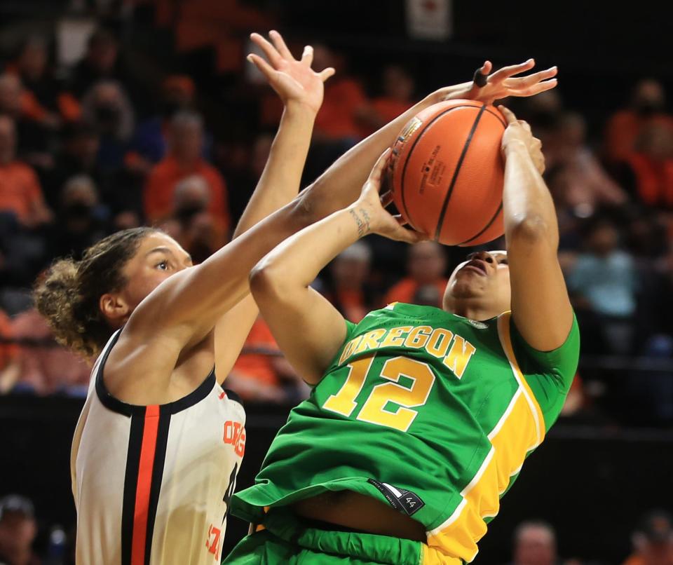 Oregon State’s Donovyn Hunter, left, blocks a shot by Oregon’s Kennedi Williams during the second half in Corvallis Sunday, Dec. 31, 2023.