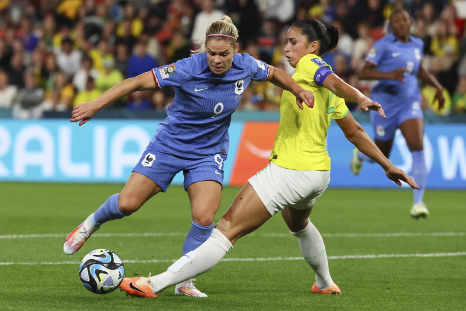 France's Eugenie Le Sommer, left, and Brazil's Rafaelle battle for the ball during the Women's World Cup Group F soccer match between France and Brazil in Brisbane, Australia, Saturday, July 29, 2023. (AP Photo/Tertius Pickard)