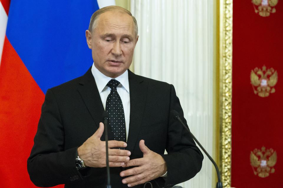 Russian President Vladimir Putin gestures while speaking to the media during a joint news conference with Hungarian Prime Minister Viktor Orban after their talks in the Kremlin in Moscow, Russia, Tuesday, Sept. 18, 2018. Putin says "a chain of tragic circumstances" is to be blamed for a Russian military aircraft shot down by a Syrian missile. He vowed to boost security for Russian troops there. (AP Photo/Alexander Zemlianichenko, Pool)