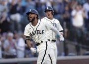 Seattle Mariners' J.P. Crawford celebrates at home with Dylan Moore behind, after hitting a grand slam off Tampa Bay Rays starting pitcher Josh Fleming during the second inning of a baseball game Saturday, June 19, 2021, in Seattle. (AP Photo/John Froschauer)