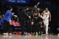 Orlando Magic forward Paolo Banchero (5) celebrates with teammates after making a 3-point basket over Los Angeles Lakers forward Troy Brown Jr. (7) during the first half of an NBA basketball game Sunday, March 19, 2023, in Los Angeles. (AP Photo/Marcio Jose Sanchez)