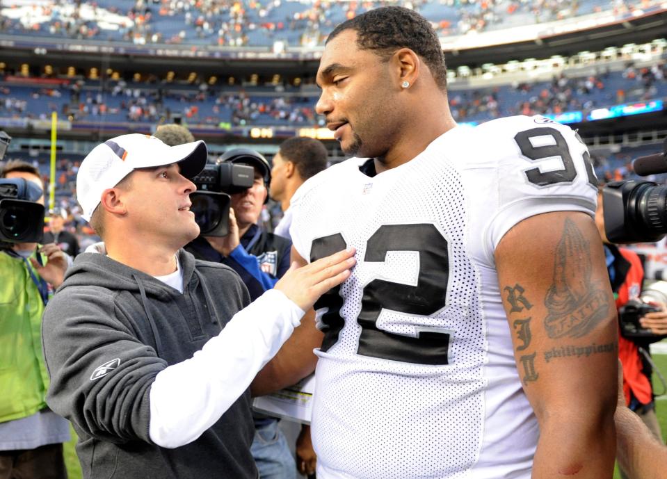 Broncos head coach Josh McDaniels talks with Raiders defensive end Richard Seymour following a game  Oct. 24, 2010, in Denver. McDaniels and Seymour won four Super Bowls together in New England. (AP Photo/ Jack Dempsey )