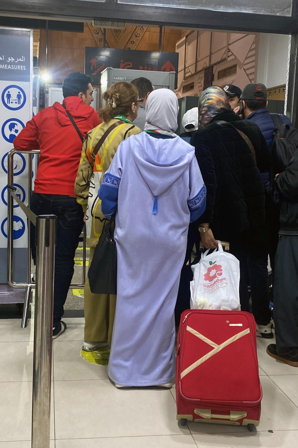 Moroccan fans heading to Qatar to support their team queue up in Casablanca airport after their flights were cancelled, in Casablanca, Morocco, Wednesday, Dec. 14, 2022. (AP Photo)