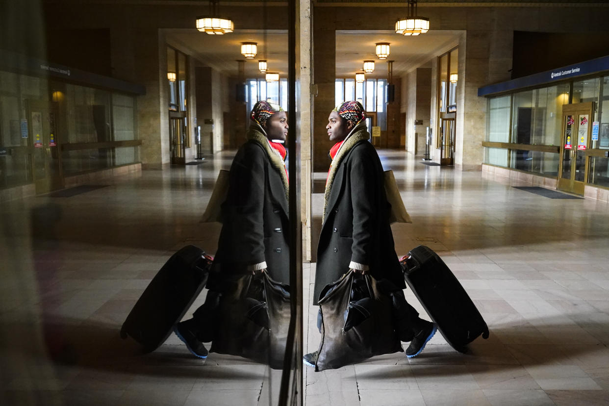 A travel moves through 30th Street Station in Philadelphia, Wednesday, Dec. 21, 2022. (AP Photo/Matt Rourke)