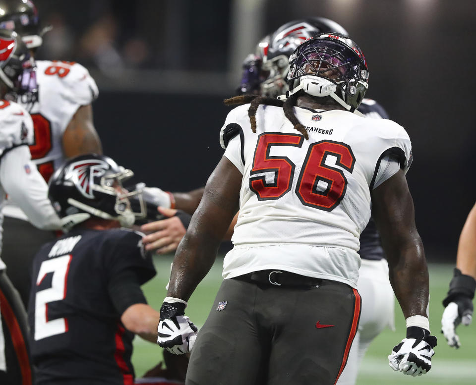 Atlanta Falcons quarterback Matt Ryan is helped up from the turf as Tampa Bay Buccaneers defensive lineman Rakeem Nunez-Roches celebrates the sack by his teammates in an NFL football game, Sunday, Dec 5, 2021, in Atlanta. (Curtis Compton/Atlanta Journal-Constitution via AP)