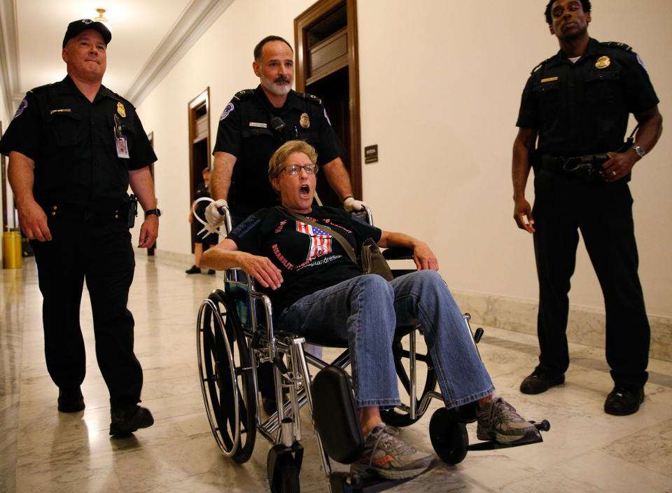 <p>A protester is escorted by police after being arrested during a demonstration outside Senate Majority Leader Mitch McConnell’s constituent office after Senate Republicans unveiled their healthcare bill on Capitol Hill in Washington, June 22, 2017. (Photo: Kevin Lamarque/Reuters) </p>