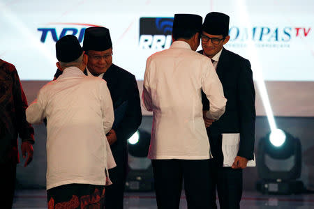 Indonesia's presidential candidate Joko Widodo and his running mate Ma'ruf Amin shake hands with their opponents Prabowo Subianto and Sandiaga Uno before a televised debate in Jakarta, Indonesia January 17, 2019. REUTERS/Willy Kurniawan