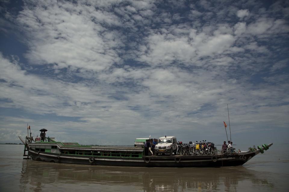 In this Aug. 6, 2018 photo, a local ferry crosses the Brahmaputra river near Majuli, in the northeastern Indian state of Assam. Majuli is said to be one of the largest river islands in the world, surrounded by the fast-moving waters of the massive, though braided, Brahmaputra river. (AP Photo/Anupam Nath)