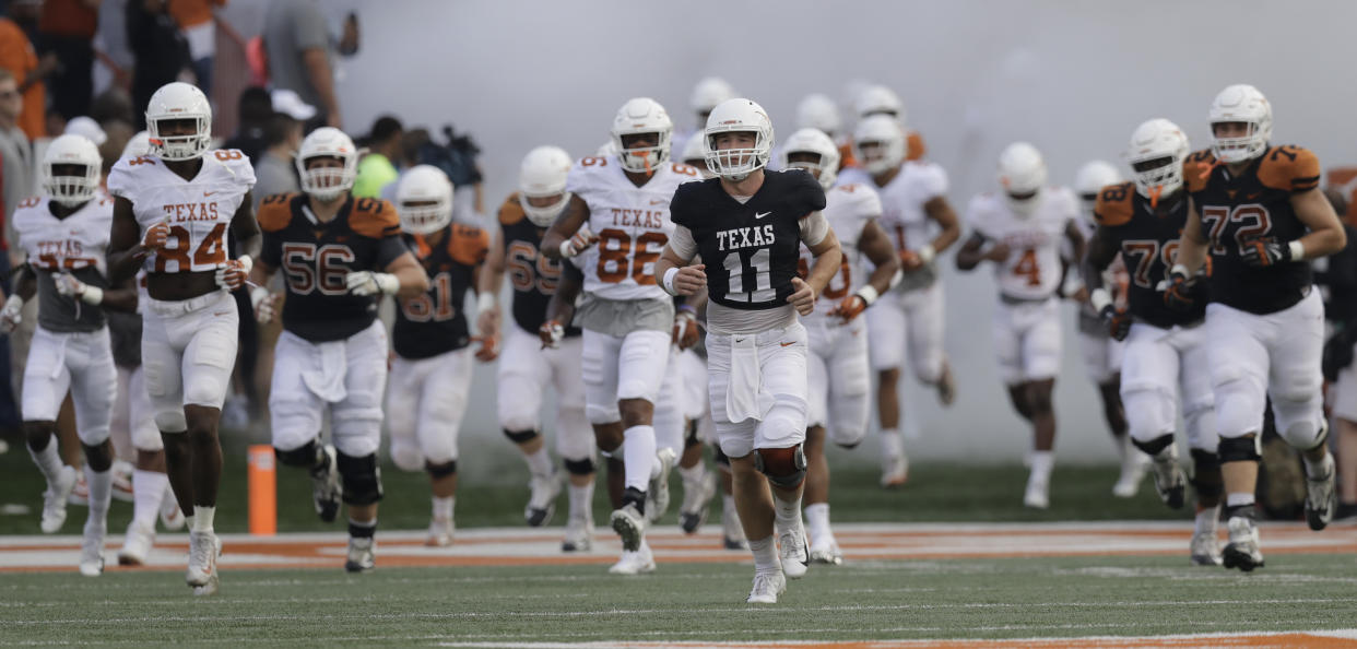 Texas quarterback Sam Ehlinger (11) leads the team on to the field during the team’s Orange-White intrasquad spring college football game, Saturday, April 21, 2018, in Austin, Texas. (AP Photo/Eric Gay)