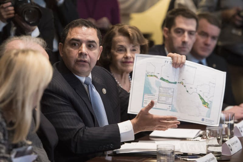 Rep. Henry Cuellar, R-Texas, holds up a map related to the border wall during a bipartisan congressional meeting on immigration in 2018. File Photo by Kevin Dietsch/UPI