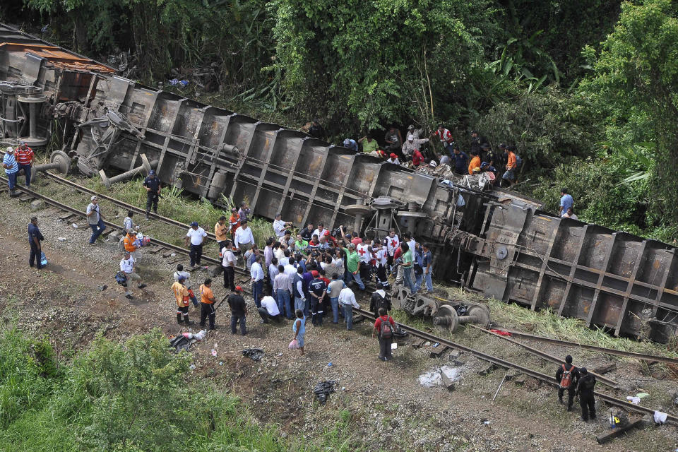 In this image released by the Tabasco state government press office on Sunday Aug. 25, 2013, rescue workers try to evacuate the injured after a cargo train, known as "the Beast", derailed near the town of Huimanguillo, southern Mexico. The cargo train, carrying at least 250 Central American hitchhiking migrants derailed in a remote region, killing at least five people and injuring dozens, authorities said. (Tabasco state government press office/AP)