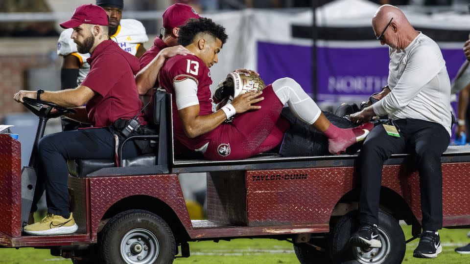 Jordan Travis is taken off the field after being injured during the first half of Florida State's game against North Alabama. - Colin Hackley/AP