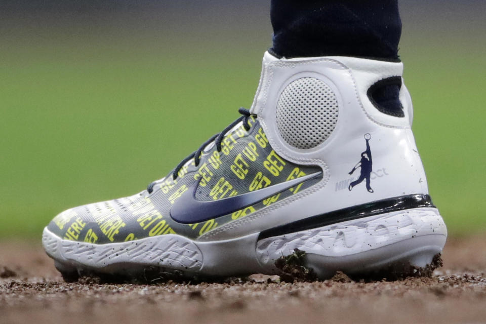 Milwaukee Brewers' Christian Yelich wears shoes honoring broadcaster Bob Uecker during the second inning of a baseball game against the New York Mets Saturday, Sept. 25, 2021, in Milwaukee. (AP Photo/Aaron Gash)