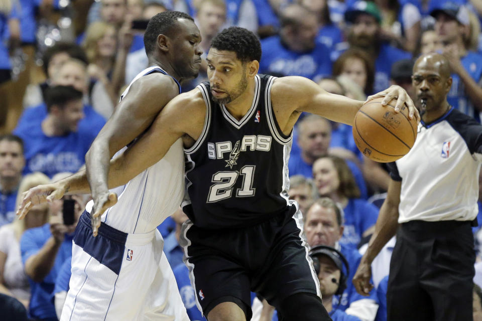 San Antonio Spurs forward Tim Duncan (21) is defended by Dallas Mavericks center Samuel Dalembert (1) during the first half of Game 3 of an NBA basketball first-round playoff series in Dallas, Saturday, April 26, 2014. (AP Photo/LM Otero)