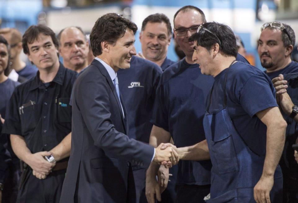 Prime Minister Justin Trudeau greets workers as he tours a garage of the Montreal Transportation Commission, Wednesday, April 6, 2016 in Montreal. THE CANADIAN PRESS/Paul Chiasson