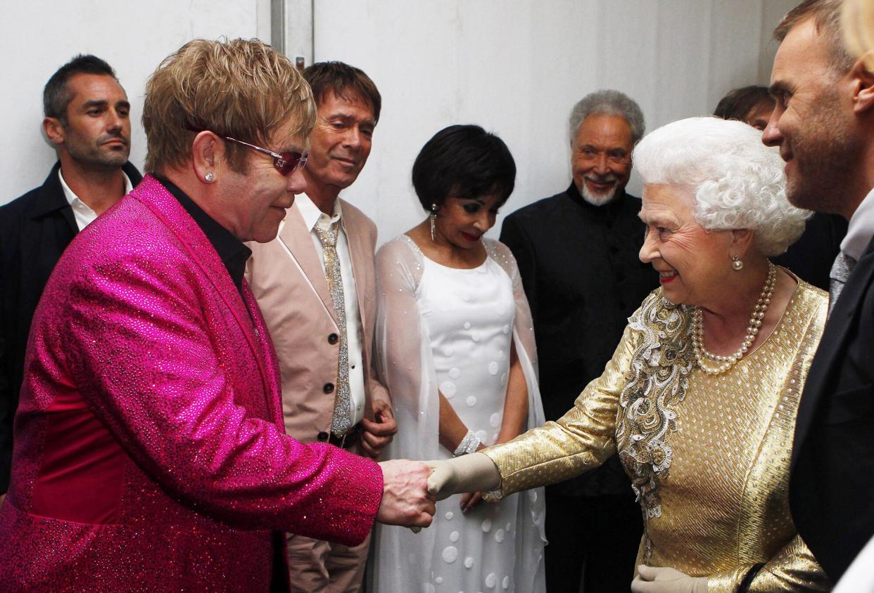 Queen Elizabeth II is introduced to Sir Elton John
