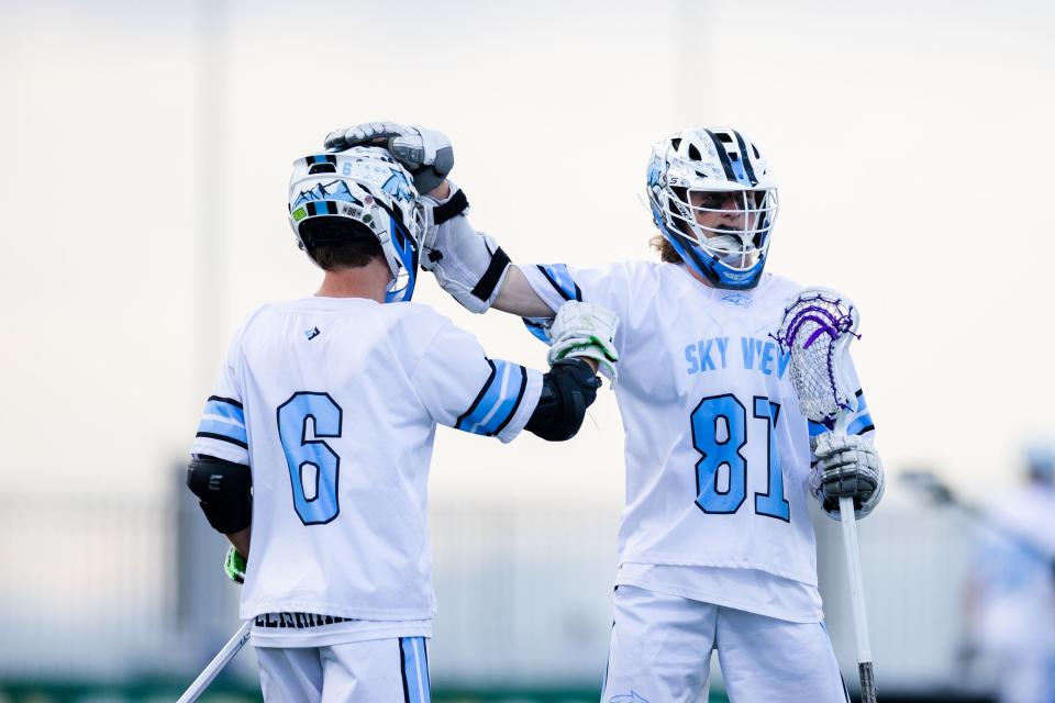 Sky View’s Gage Leishman (6) is congratulated by teammate Sean Tempest (81) during the 4A boys lacrosse championships at Zions Bank Stadium in Herriman on May 26, 2023. | Ryan Sun, Deseret News