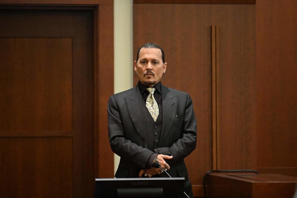 US actor Johnny Depp testifies during his defamation trial in the Fairfax County Circuit Courthouse in Fairfax, Virginia, on April 19, 2022. - Depp is suing ex-wife Amber Heard for libel after she wrote an op-ed piece in The Washington Post in 2018 referring to herself as a public figure representing domestic abuse. (Photo by JIM WATSON / POOL / AFP) (Photo by JIM WATSON/POOL/AFP via Getty Images)