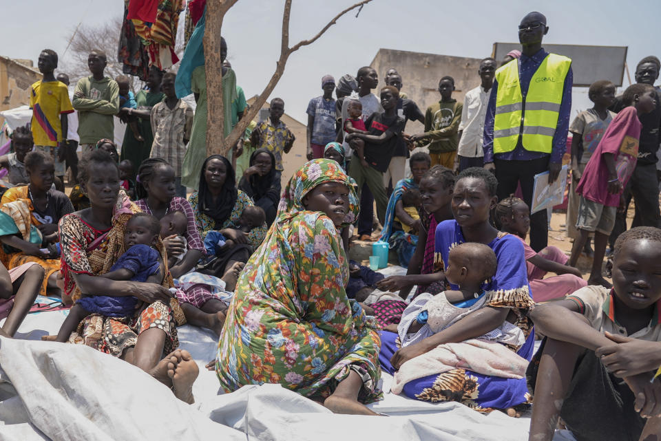 South Sudanese who fled from Sudan sit outside a nutrition clinic at a transit center in Renk, South Sudan Tuesday, May 16, 2023. Tens of thousands of South Sudanese are flocking home from neighboring Sudan, which erupted in violence last month. (AP Photo/Sam Mednick)
