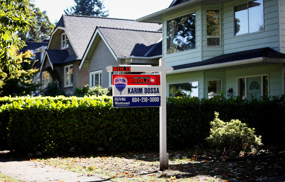A real estate for sale sign is pictured in front of a home in Vancouver, British Columbia, Canada, September 22, 2016. REUTERS/Ben Nelms