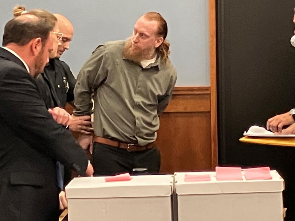 Nathan Olsen is handcuffed after being found guilty on nine counts, including aggravated murder, in Richland County Common Pleas Court on Friday.
