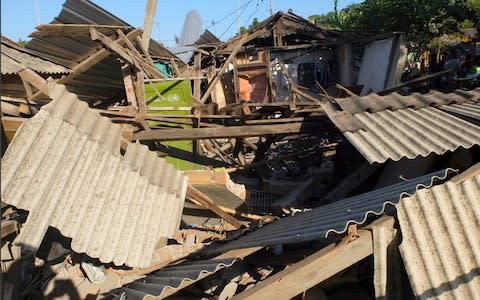 Houses damaged by an earthquake are seen in North Lombok, Indonesia - Credit: AP