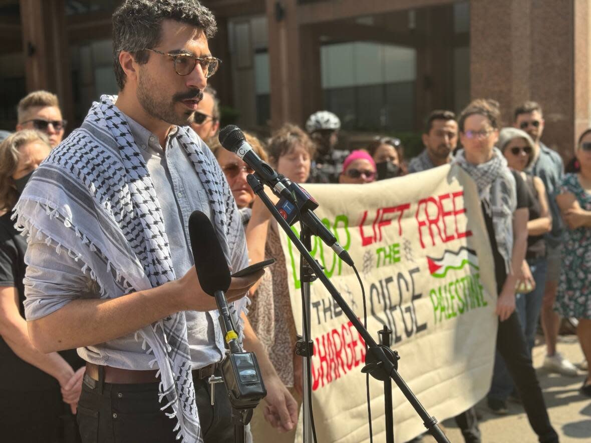 Karl Gardner speaks at a protest outside Toronto police headquarters on Wednesday, May 22, 2024. Gardner is one of four people whose charges, in connection with the vandalization of an Indigo bookstore last fall, were dropped on May 17.   (Chris Glover/CBC - image credit)