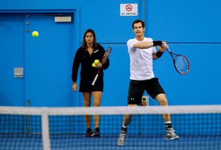 Britain's Andy Murray hits a shot as his coach Amelie Mauresmo watches during a practice session at the Australian Open tennis tournament at Melbourne Park, Australia, January 22, 2016. REUTERS/Jason O'Brien